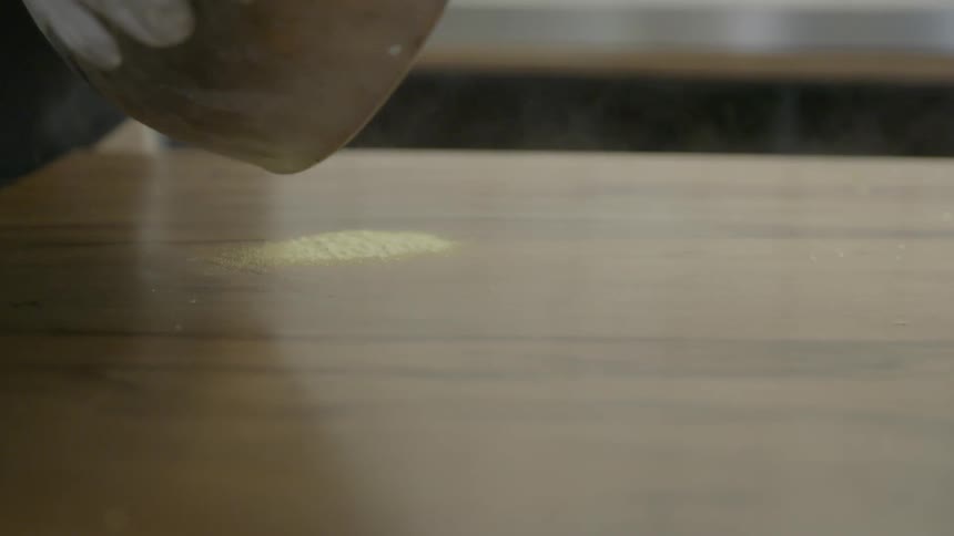 Frozen food is poured from a metal bowl