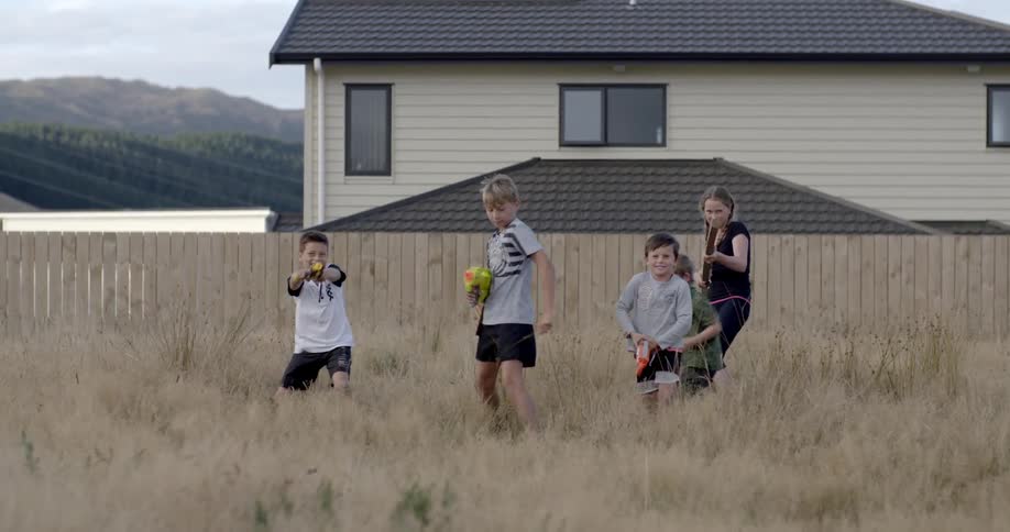 Children jump up with toy guns in their hands