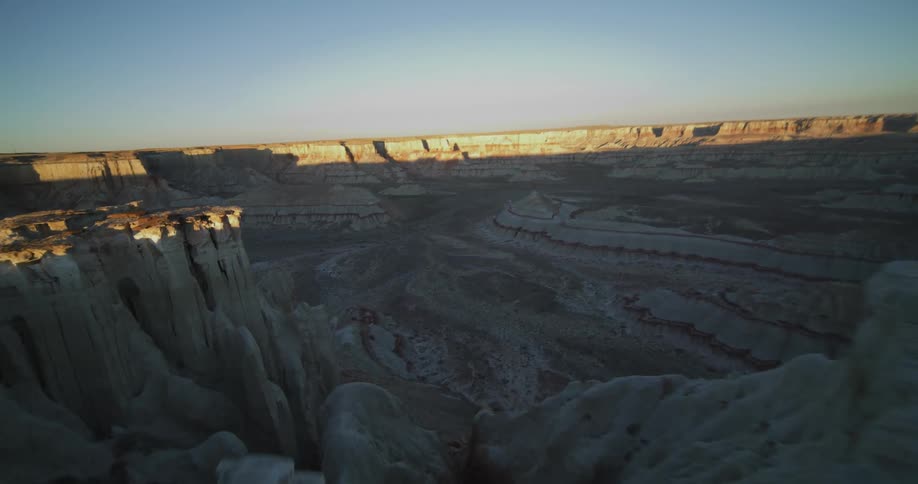 A person is driving a car off road in a rocky terrain