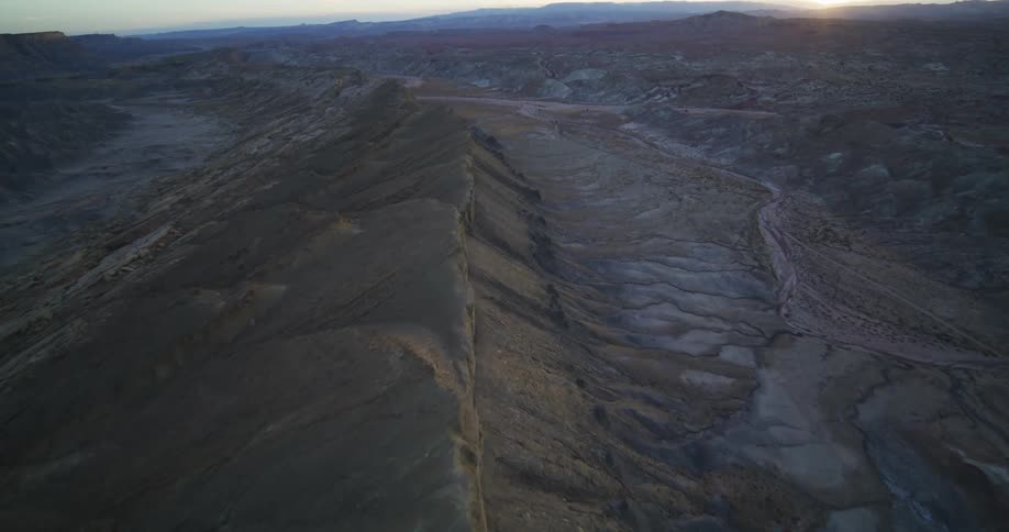 An aerial view of a landscape with a canyon and cliffs