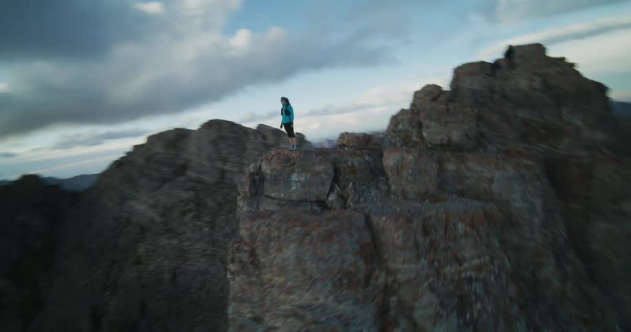 Aerial view of a person is rock climbing at dusk