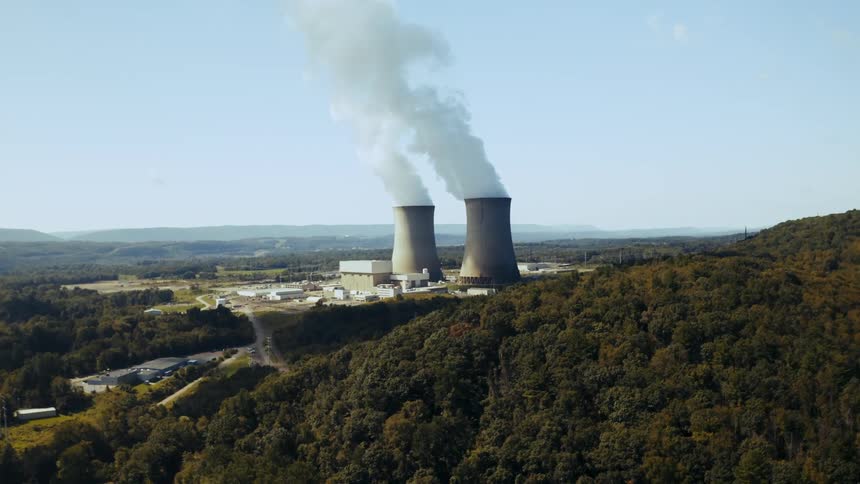 Thick smokes rises from tall columns outside a nuclear power plant