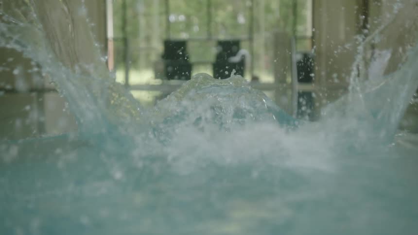 A woman dives into a swimming pool