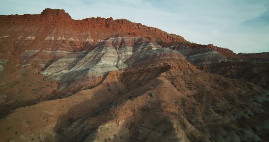 Horizontal lines form different tones on the side of a canyon