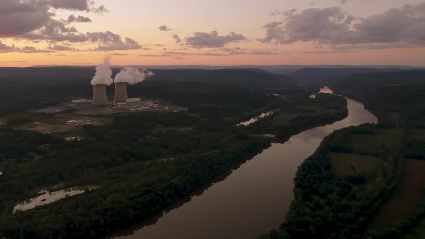 An aerial view of smoke pouring out of a nuclear power plant next to the Susquehanna river