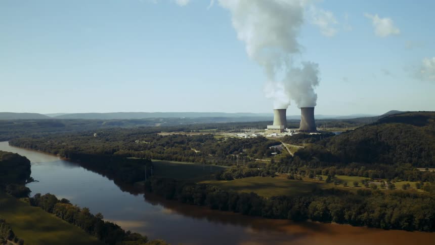 Smoke bellows out of two smoke stacks at a nuclear power station