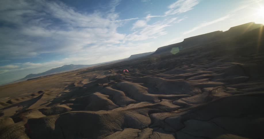 Sand dunes form shallow hills in the desert