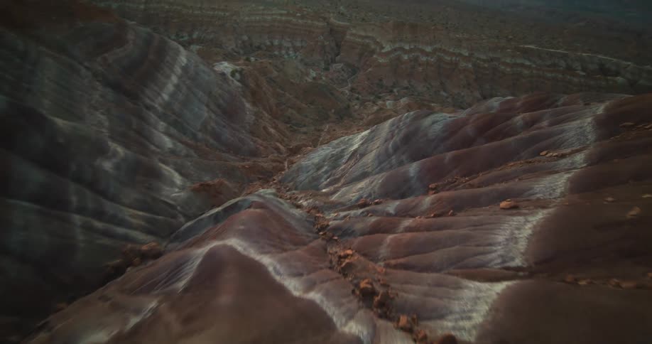 White dust covers the peaks of a vast canyon