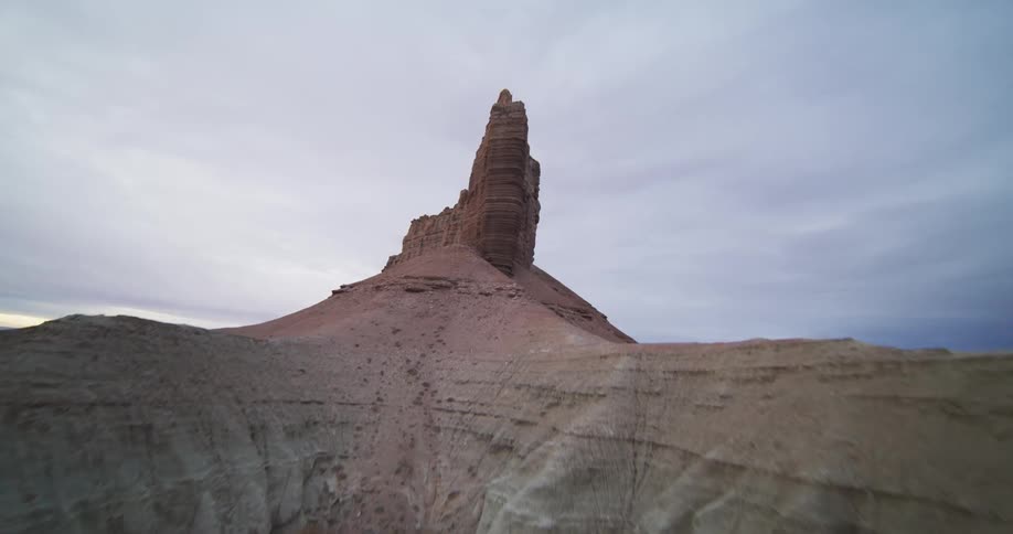 Rock formations in the desert badlands under a cloudy sky