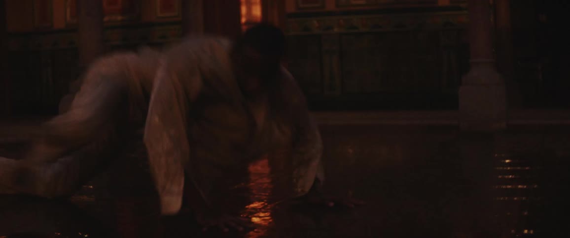 A man is dancing in a dark lit room