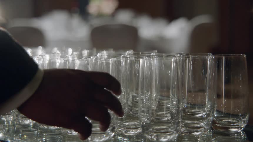 A glass is placed on a counter with other glasses
