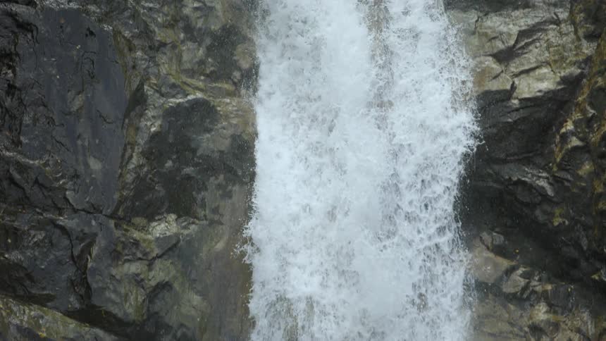 A panning shot of a waterfall