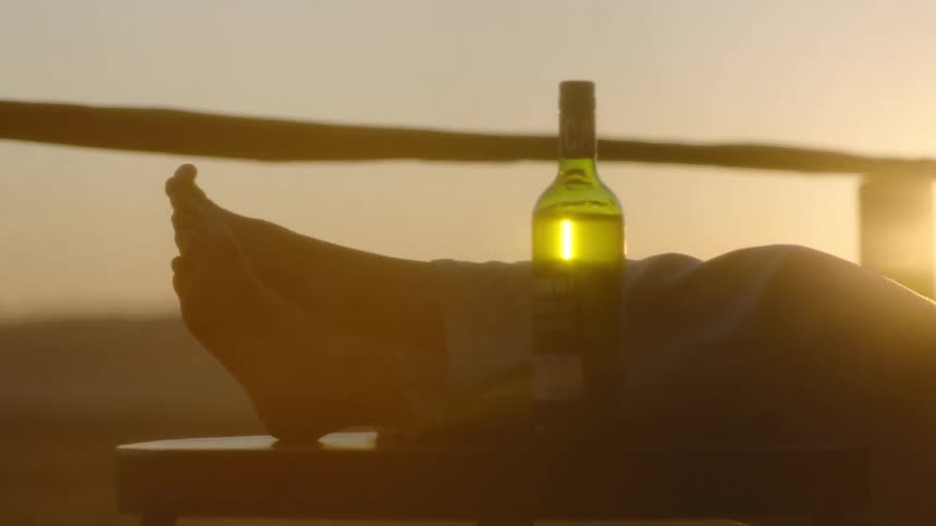 Young woman outdoors, enjoying sunset