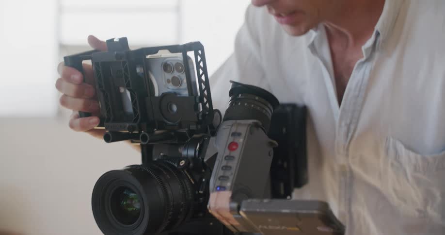 A man is using a camera in the room
