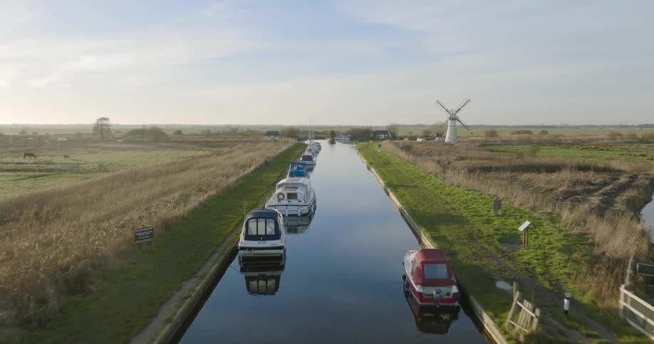 Boats are parked on the water in a rural area