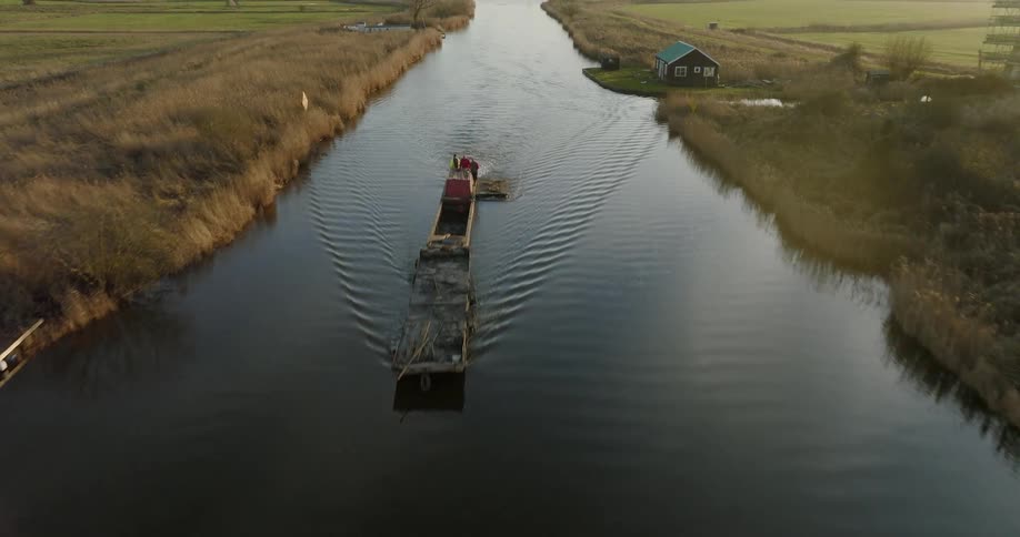 A cargo ship moves down the canal