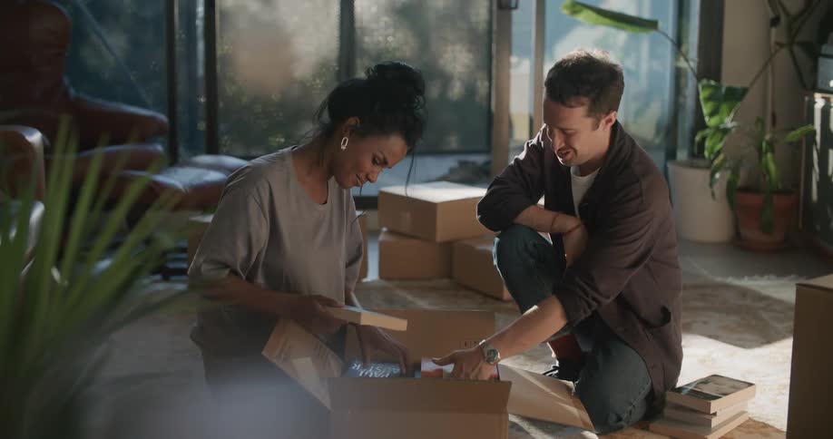 A view of two people unloading boxes