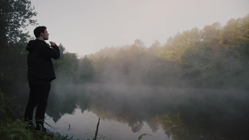 A man walks to the lake to look over it