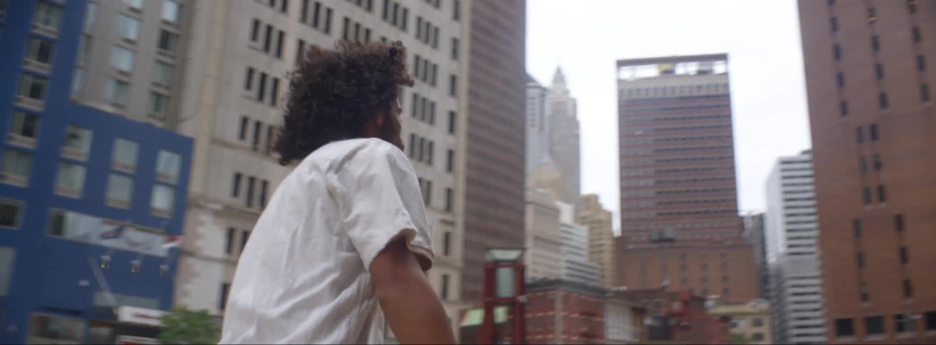 Man skateboarding through a city