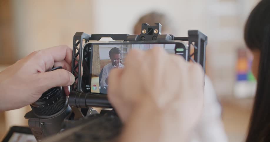 A man is adjusting camera settings