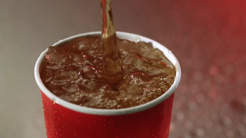 The cup is filled with soda and ice