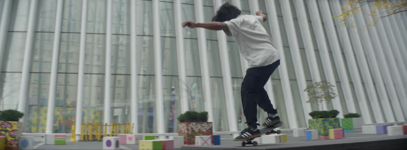 A person is skateboarding outdoors in a city