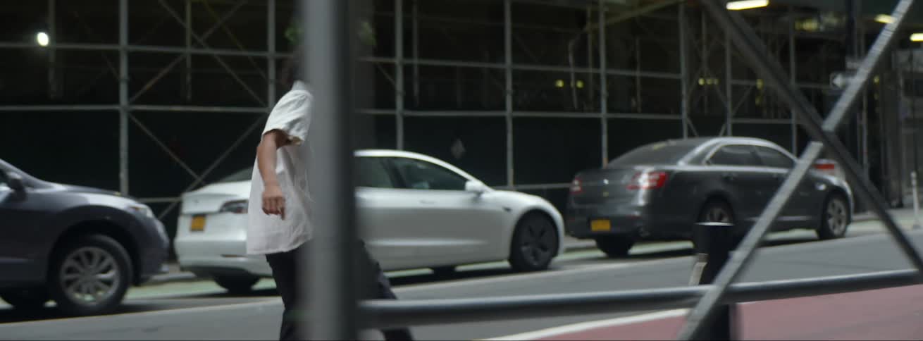 A man rides his skateboard down the city street
