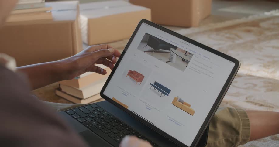 A person looking at items on a laptop screen indoors