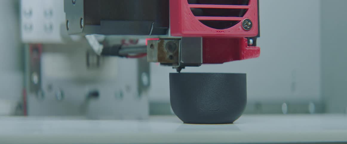 A machine is building something on the table