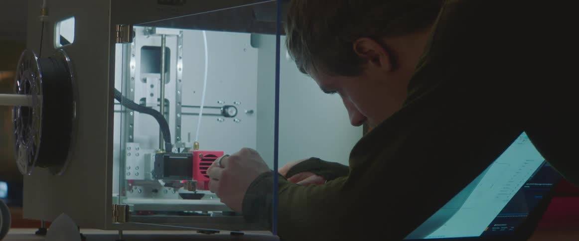 Person working on 3d printer