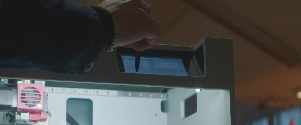 A person working on a 3d printer