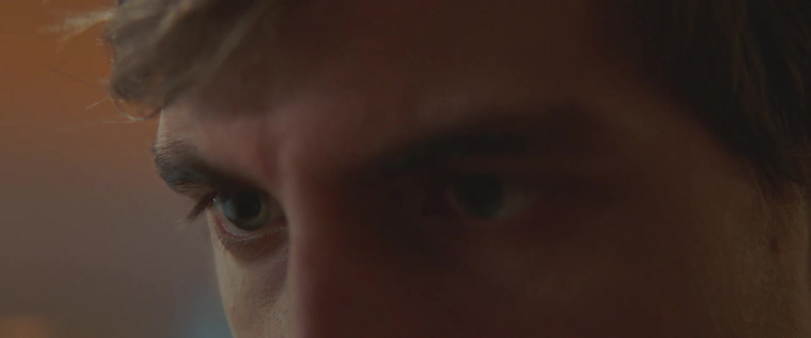 The eyes of a man who is looking forward and blinking