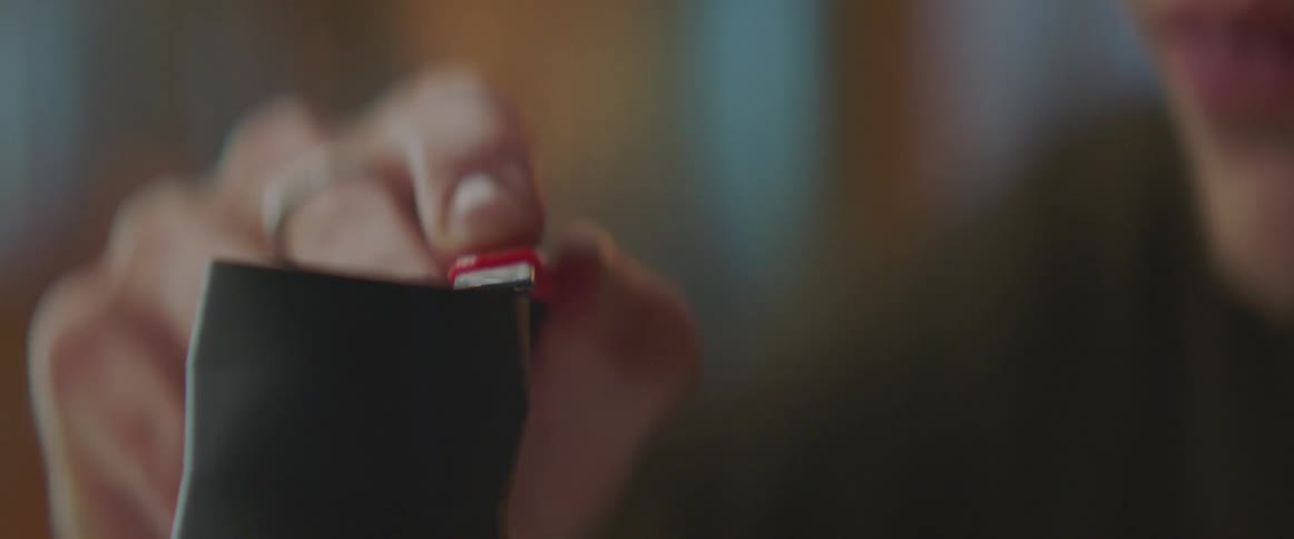 A man uses a razor to smooth the top of a cylinder