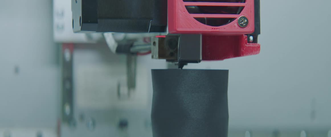 A view of a 3d printer working on a cup