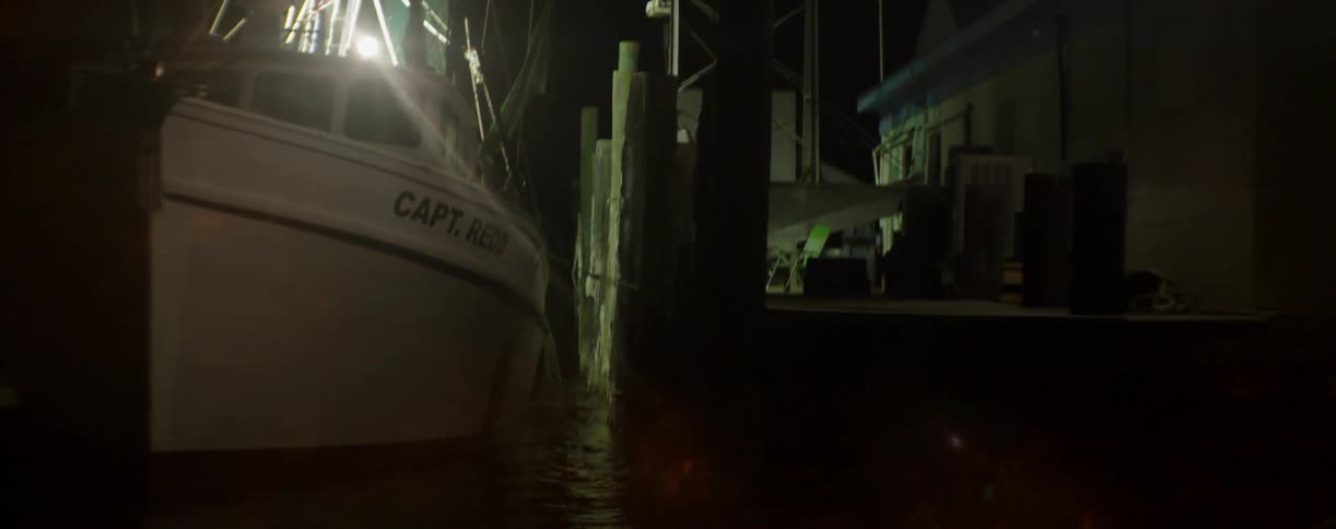 A boat is docked at night