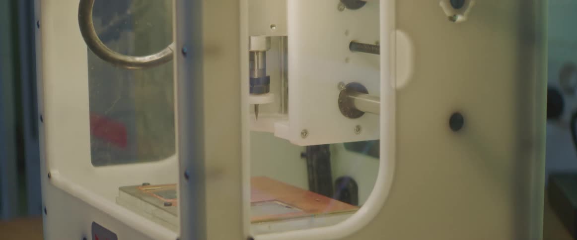 A three dimensional printer moves left and right