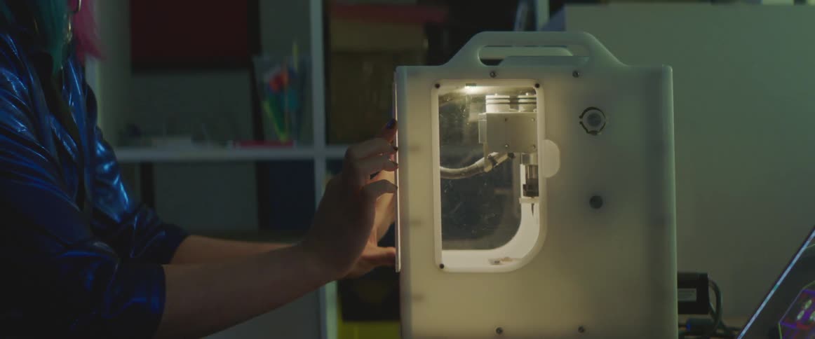 An employee putting the door on a piece of work equipment