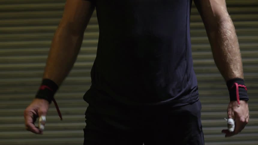 A man breathes heavy before walking forward