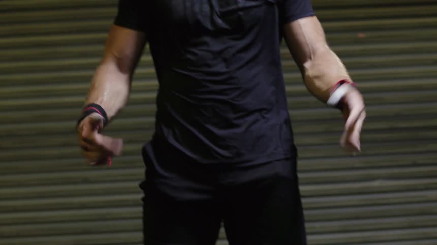 A man wipes his hands and stretches