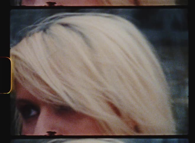 Blonde woman sits near fountain
