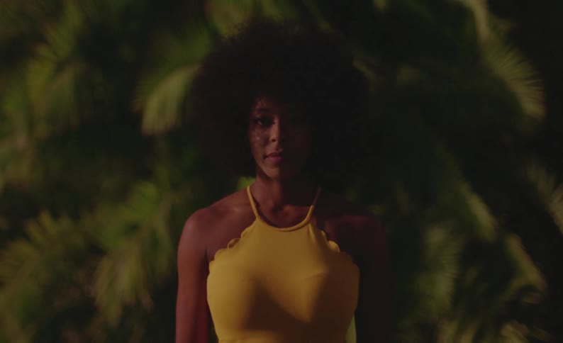 Woman wearing yellow poses outdoors