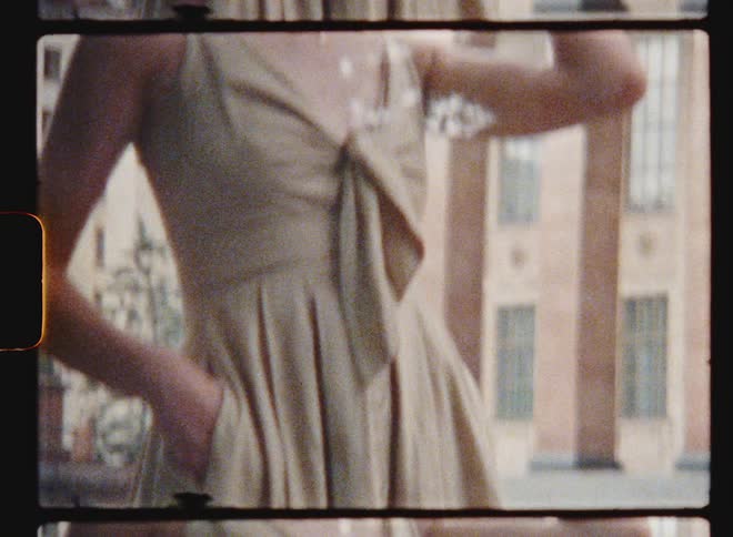 A model poses downtown in a spaghetti strap dress