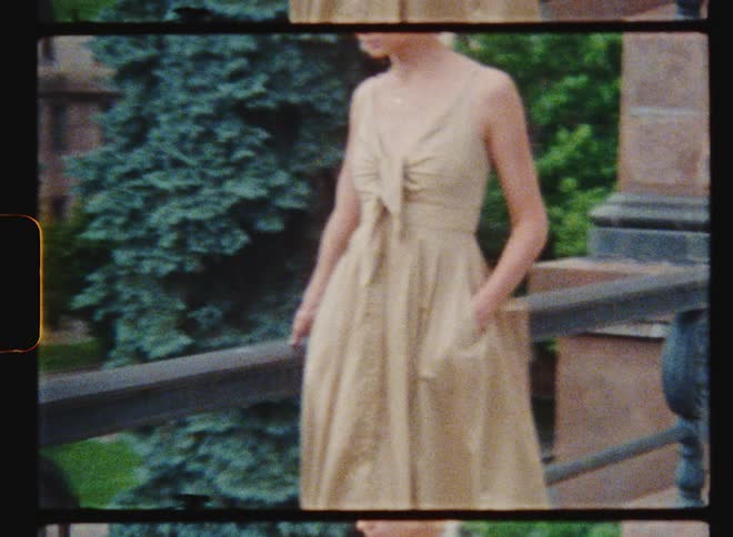 A model poses along a railing outside a downtown building