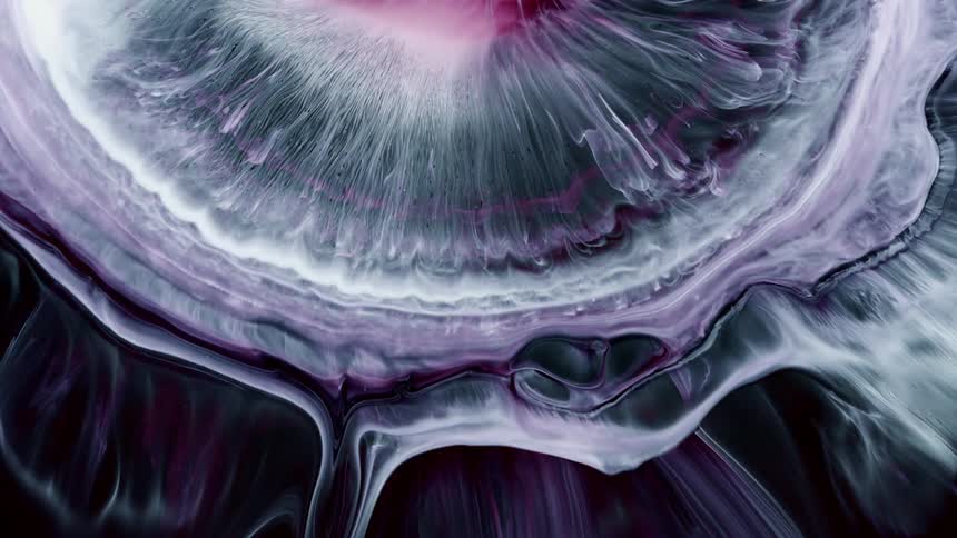 White paint expands in a sphere shape against a black background in an otherworldly scenario