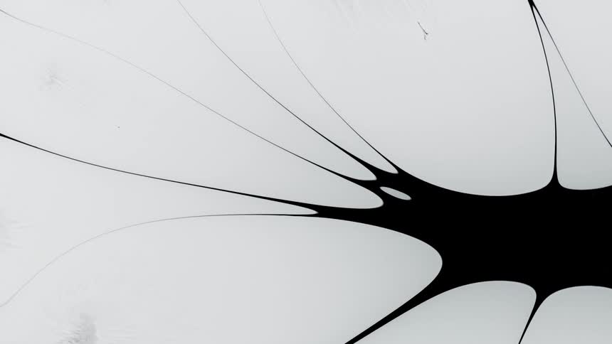 Blobs of bright white liquid ink moving over a black background