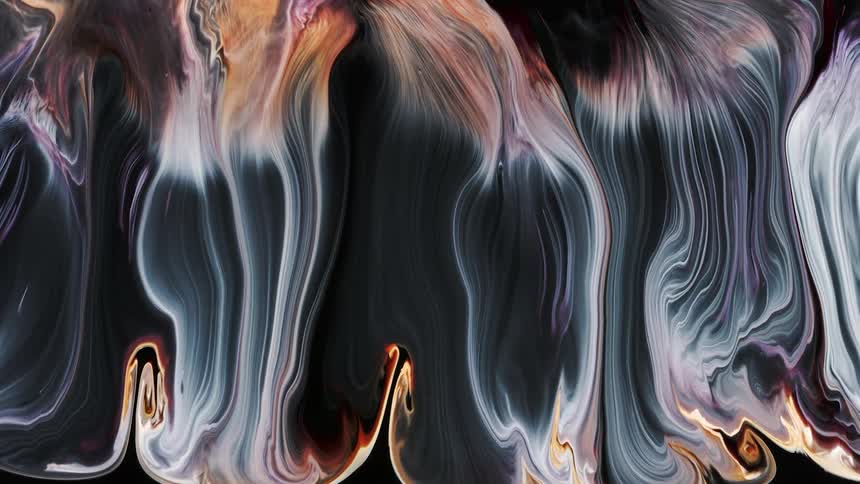 Paint colors are pouring down and mixing in a perfect organic shape with thin lines of paint