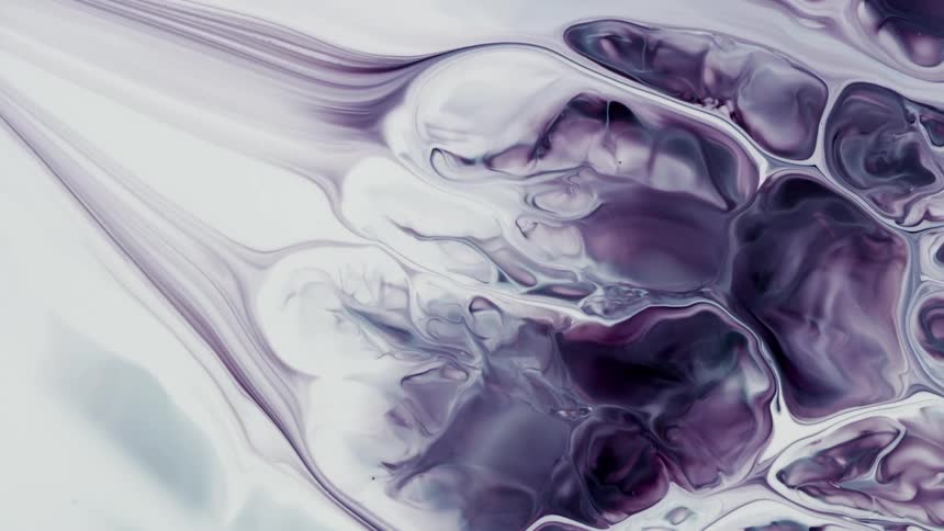 Blobs and swirls of purple liquid ink blooming on a layer of white ink