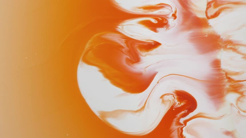 White and orange paint combine to create swirled patterns