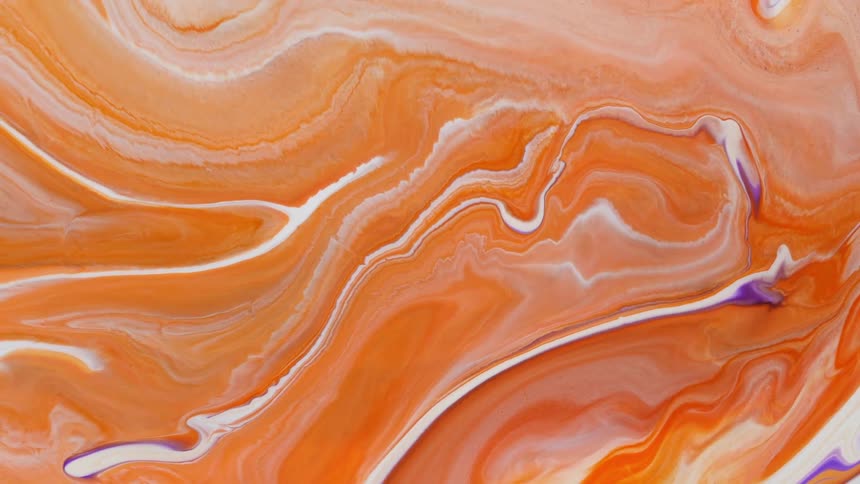 White swirly lines of paint blend into orange paint