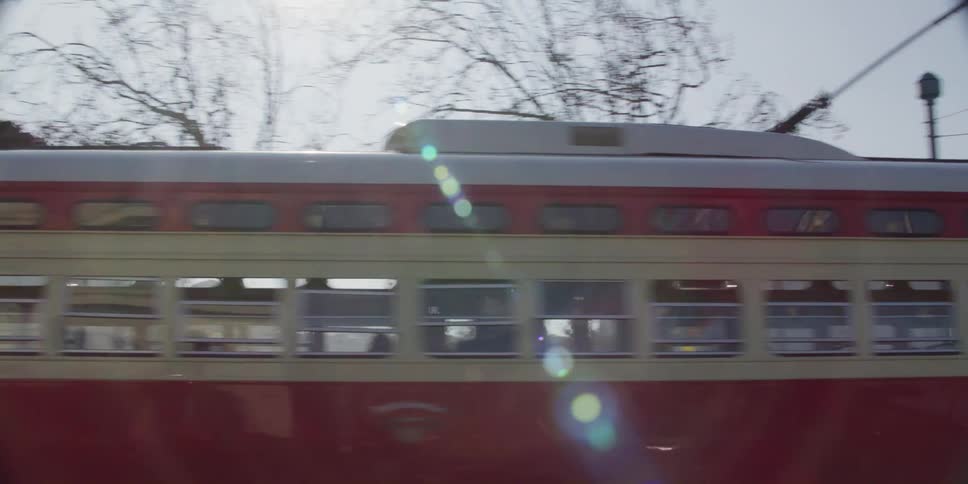 A train is moving through a neighborhood